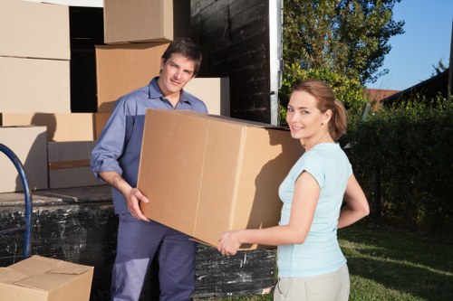 Removalist team handling packed boxes and furniture